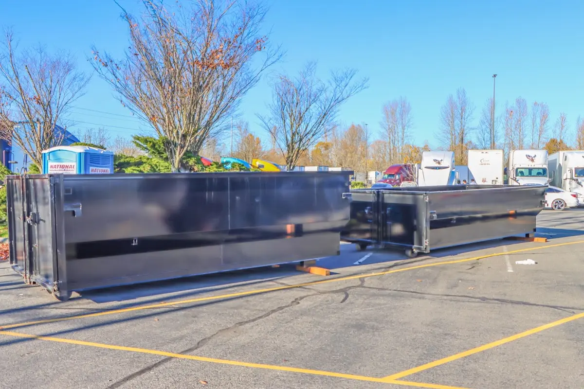 Professional dumpster rental service with roll-off container on residential driveway in Honey Brook